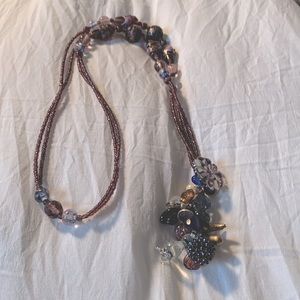 Handmade pendant with vintage beads and charms in shades of purple and rose